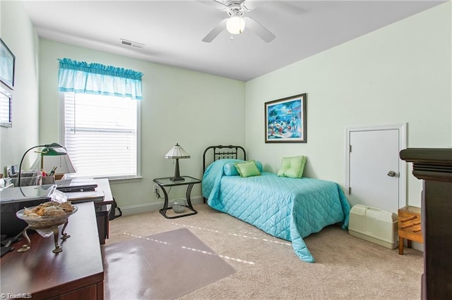 bedroom with ceiling fan and light carpet