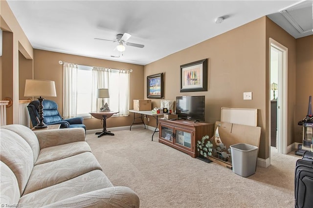 carpeted living room with ceiling fan