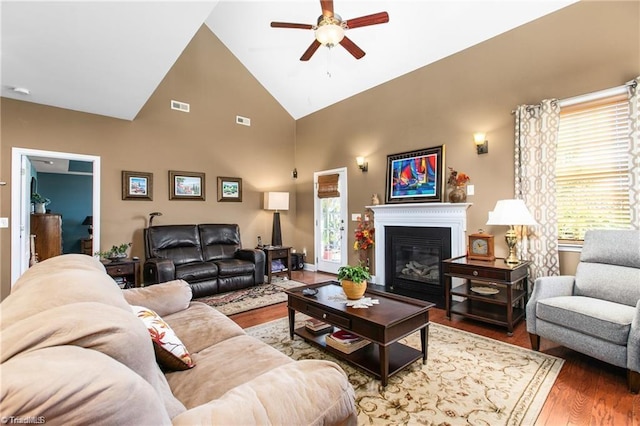 living room with ceiling fan, high vaulted ceiling, and wood-type flooring