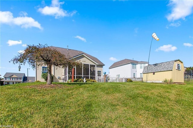 back of house featuring a sunroom and a yard