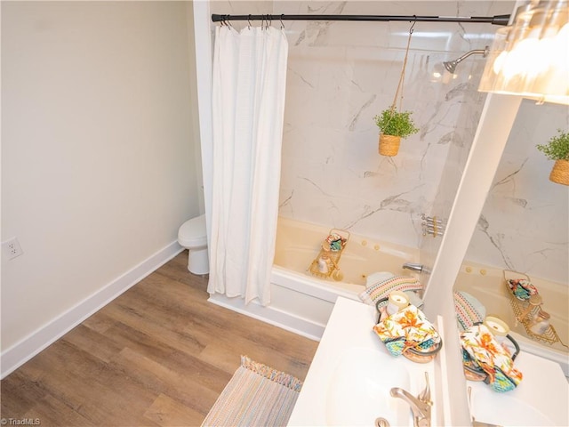 bathroom with toilet, shower / tub combo, and wood-type flooring