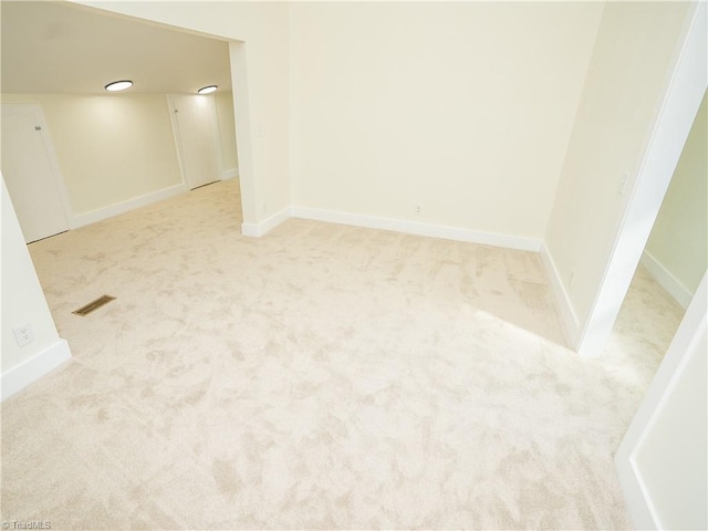 empty room featuring light colored carpet