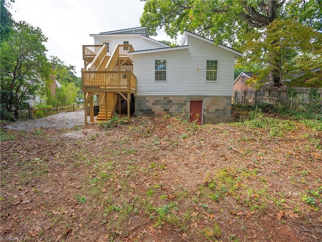 back of house featuring a wooden deck