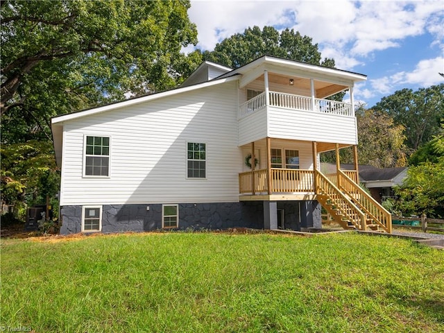 back of property featuring a yard and a balcony