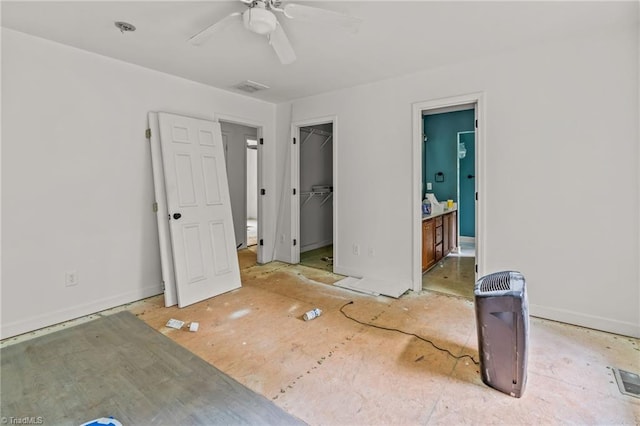 4812 Country Meadows Dr, Julian, NC 27283 - unfurnished bedroom featuring ensuite bathroom, a walk in closet, a ceiling fan, and baseboards