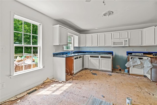 4812 Country Meadows Dr, Julian, NC 27283 - kitchen featuring white microwave, white cabinets, a sink, and baseboards