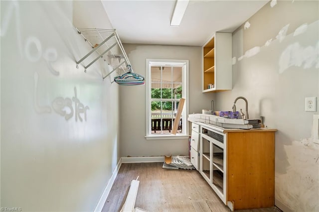 4812 Country Meadows Dr, Julian, NC 27283 - laundry area featuring light wood-type flooring and baseboards