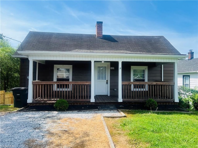 322 E Independence Blvd, Mount Airy, NC 27030 - view of front facade with roof with shingles, a porch, and a chimney