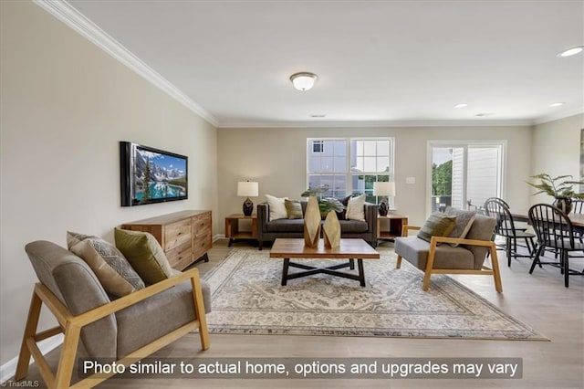 living area with wood finished floors, ornamental molding, and recessed lighting