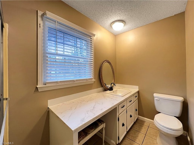 bathroom featuring toilet, a textured ceiling, tile patterned floors, and vanity