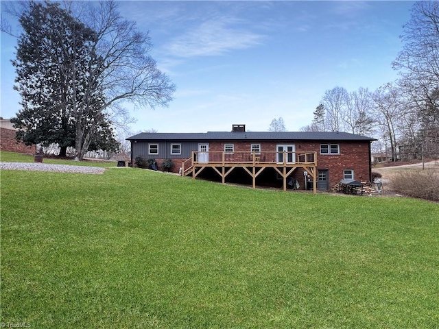 view of front of home with a wooden deck and a front lawn