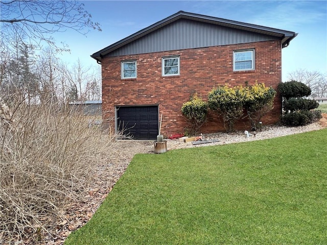 view of side of property with a garage and a yard