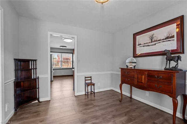 living area featuring baseboards and wood finished floors