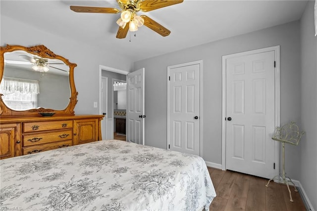 bedroom featuring dark wood-style flooring, ceiling fan, and baseboards