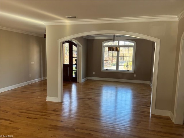 unfurnished room with dark hardwood / wood-style flooring and crown molding