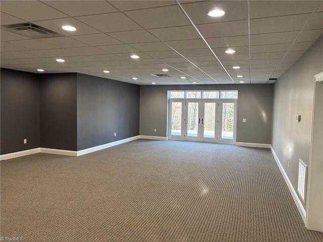 carpeted spare room with french doors