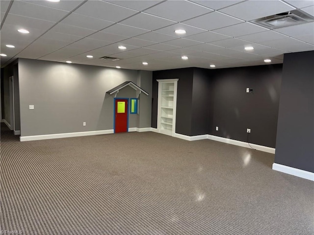 basement featuring carpet floors and a drop ceiling