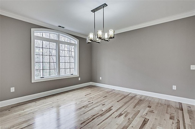 unfurnished room with crown molding, a notable chandelier, and light wood-type flooring