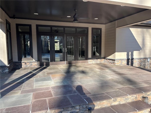 property entrance featuring french doors, ceiling fan, and a patio