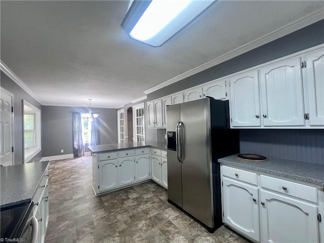 5608 Fred Lineberry Rd, Randleman, NC 27317 - kitchen with stainless steel appliances, a peninsula, crown molding, white cabinets, and decorative light fixtures