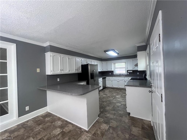 5608 Fred Lineberry Rd, Randleman, NC 27317 - kitchen featuring appliances with stainless steel finishes, a peninsula, a sink, white cabinets, and a textured ceiling