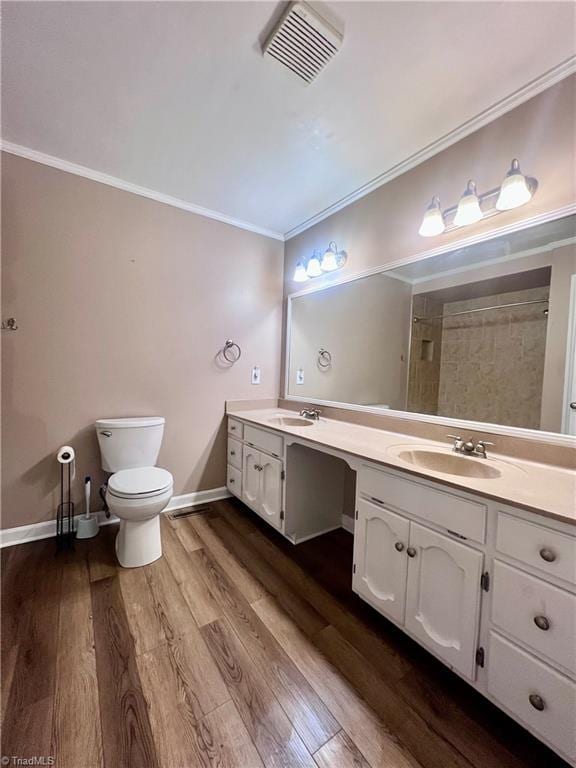 5608 Fred Lineberry Rd, Randleman, NC 27317 - full bath featuring crown molding, double vanity, toilet, wood finished floors, and baseboards