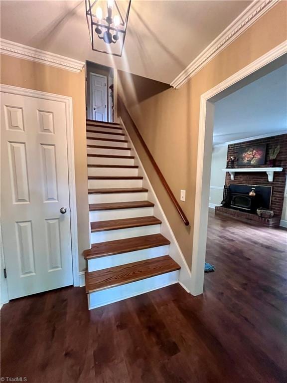 5608 Fred Lineberry Rd, Randleman, NC 27317 - stairway featuring a chandelier, ornamental molding, wood finished floors, a fireplace, and baseboards