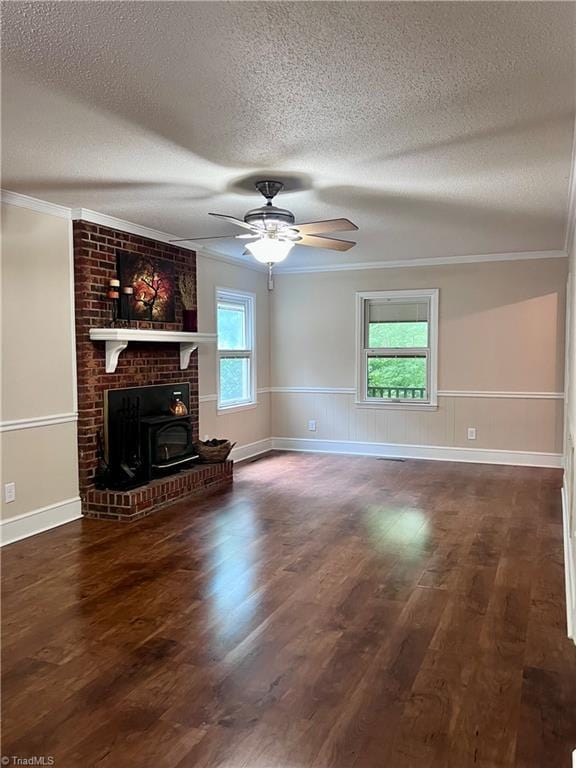 5608 Fred Lineberry Rd, Randleman, NC 27317 - unfurnished living room with a textured ceiling, crown molding, wood finished floors, a wainscoted wall, and a ceiling fan