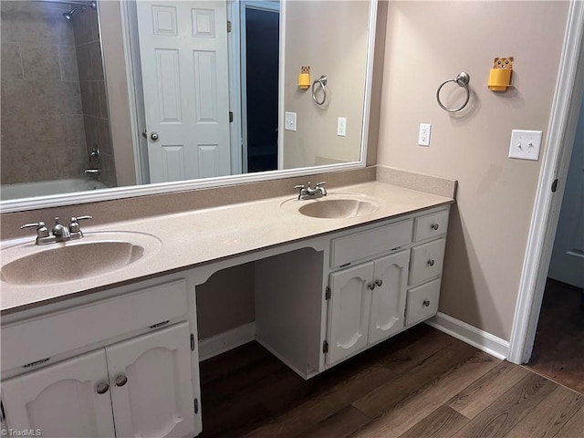 5608 Fred Lineberry Rd, Randleman, NC 27317 - bathroom featuring double vanity, wood finished floors, baseboards, and bathtub / shower combination