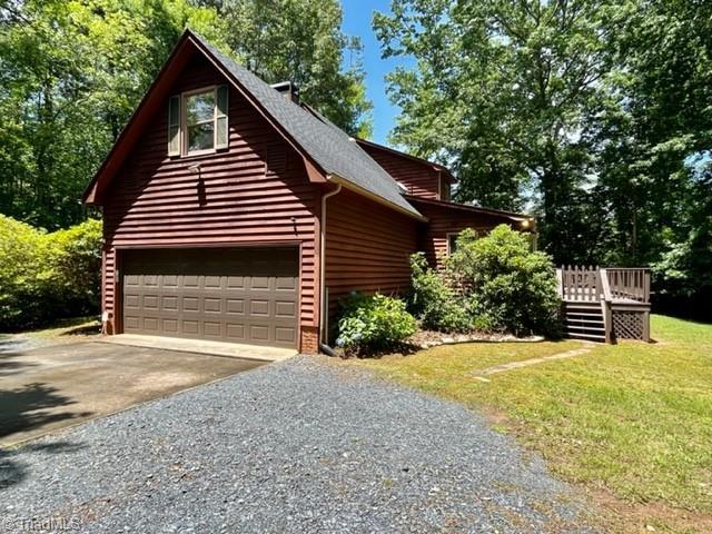 5608 Fred Lineberry Rd, Randleman, NC 27317 - view of side of home featuring concrete driveway, a wooden deck, and a yard