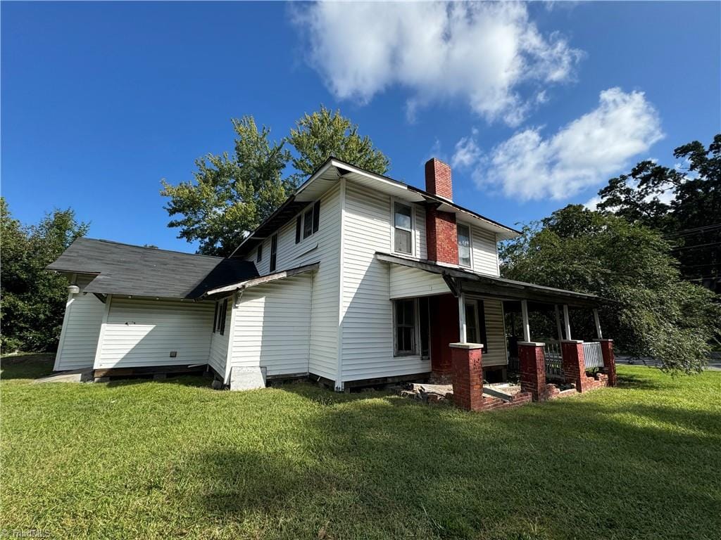 back of house with a lawn