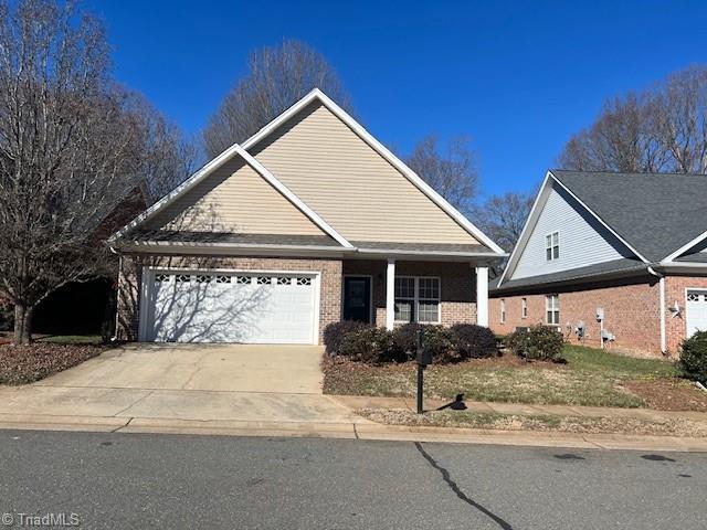 view of front of home featuring brick siding, driveway, and an attached garage