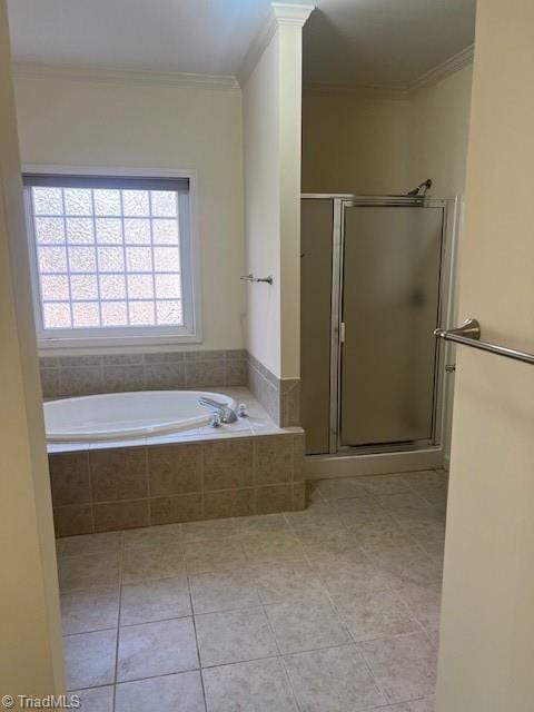 bathroom featuring tile patterned flooring, crown molding, a shower stall, and decorative columns