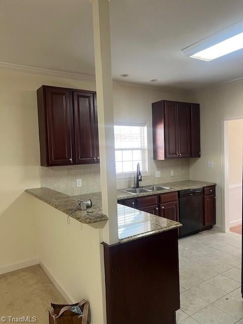 kitchen featuring tasteful backsplash, black dishwasher, a sink, and a peninsula