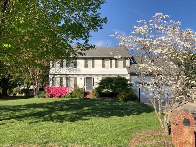 3908 Sandlewood Rd, High Point, NC 27265 - colonial-style house featuring a front yard, concrete driveway, and a garage