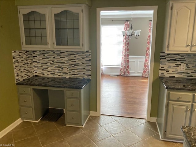 3908 Sandlewood Rd, High Point, NC 27265 - kitchen with a chandelier, tasteful backsplash, glass insert cabinets, and built in study area