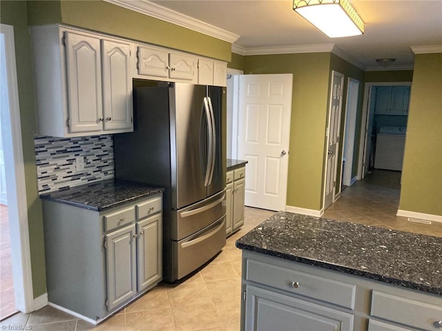 3908 Sandlewood Rd, High Point, NC 27265 - kitchen featuring freestanding refrigerator, ornamental molding, light tile patterned flooring, decorative backsplash, and dark stone countertops