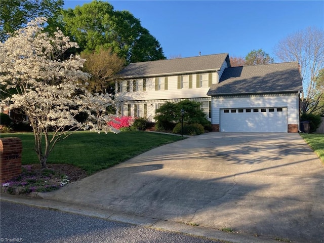 3908 Sandlewood Rd, High Point, NC 27265 - view of front of property with a garage, a front yard, driveway, and brick siding