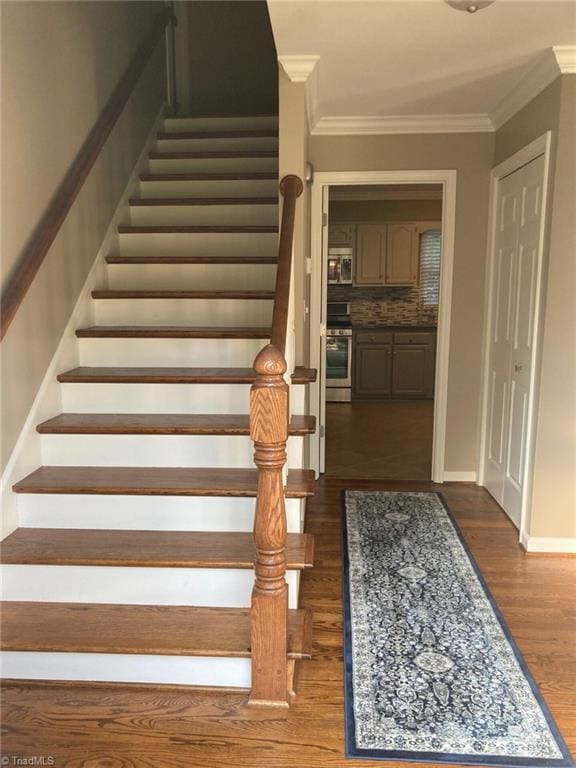 3908 Sandlewood Rd, High Point, NC 27265 - stairs featuring wood finished floors and ornamental molding