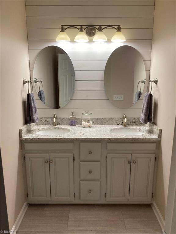 3908 Sandlewood Rd, High Point, NC 27265 - bathroom with double vanity and baseboards