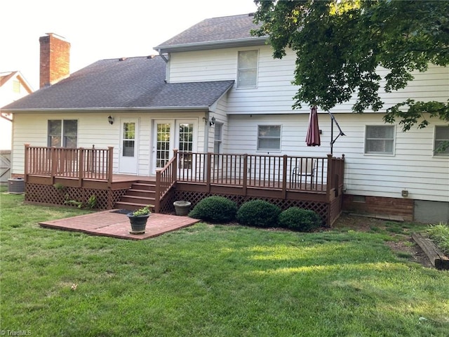 3908 Sandlewood Rd, High Point, NC 27265 - back of property featuring a deck, a shingled roof, a yard, and a chimney