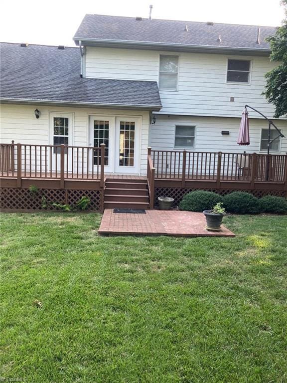 3908 Sandlewood Rd, High Point, NC 27265 - back of property with a wooden deck, a patio area, roof with shingles, and a yard
