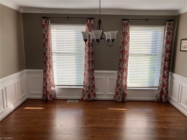 3908 Sandlewood Rd, High Point, NC 27265 - unfurnished dining area featuring ornamental molding, a chandelier, wood finished floors, a wainscoted wall, and a decorative wall