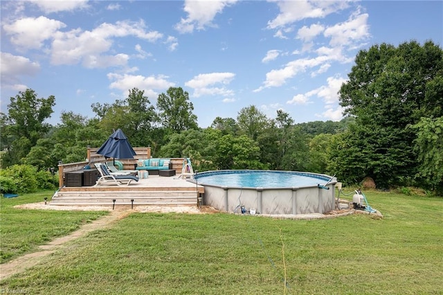 view of swimming pool with an outdoor hangout area, a deck, and a lawn