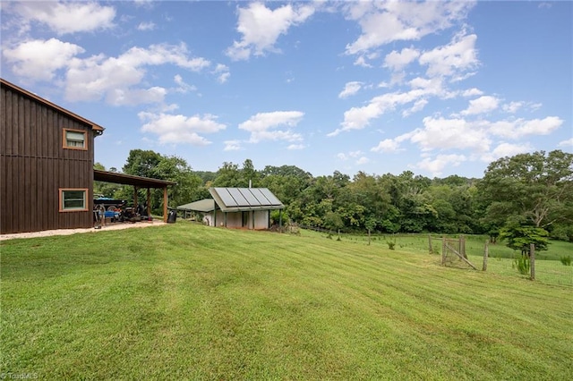 view of yard with a rural view and an outbuilding