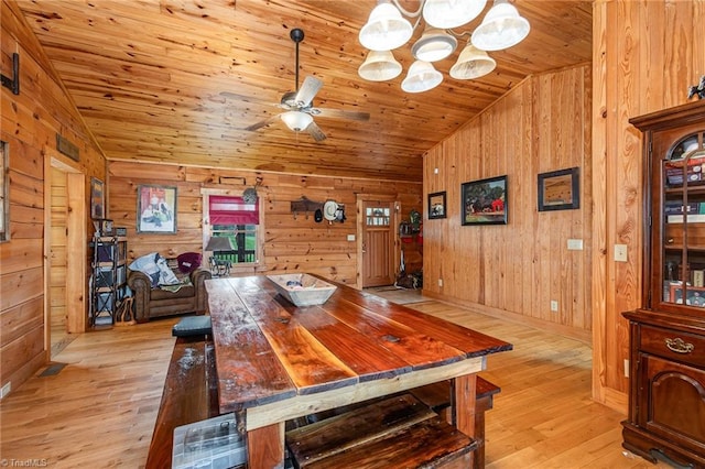 dining area featuring ceiling fan with notable chandelier, light wood-type flooring, lofted ceiling, and wood ceiling