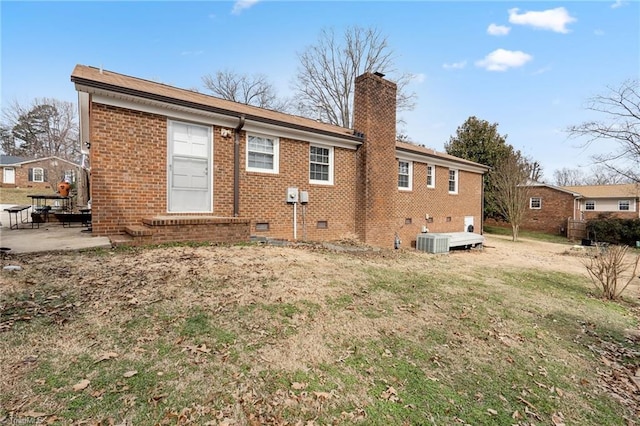 rear view of house featuring a lawn, central AC, and a patio area