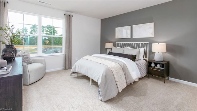 carpeted bedroom with multiple windows