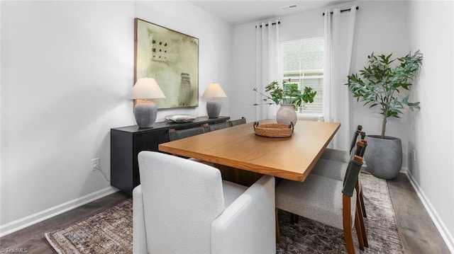 dining space with dark hardwood / wood-style flooring