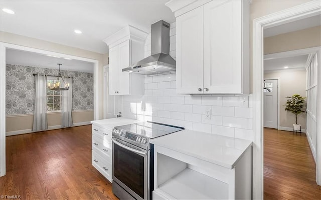 kitchen featuring white cabinets, dark hardwood / wood-style flooring, wall chimney exhaust hood, and stainless steel electric range